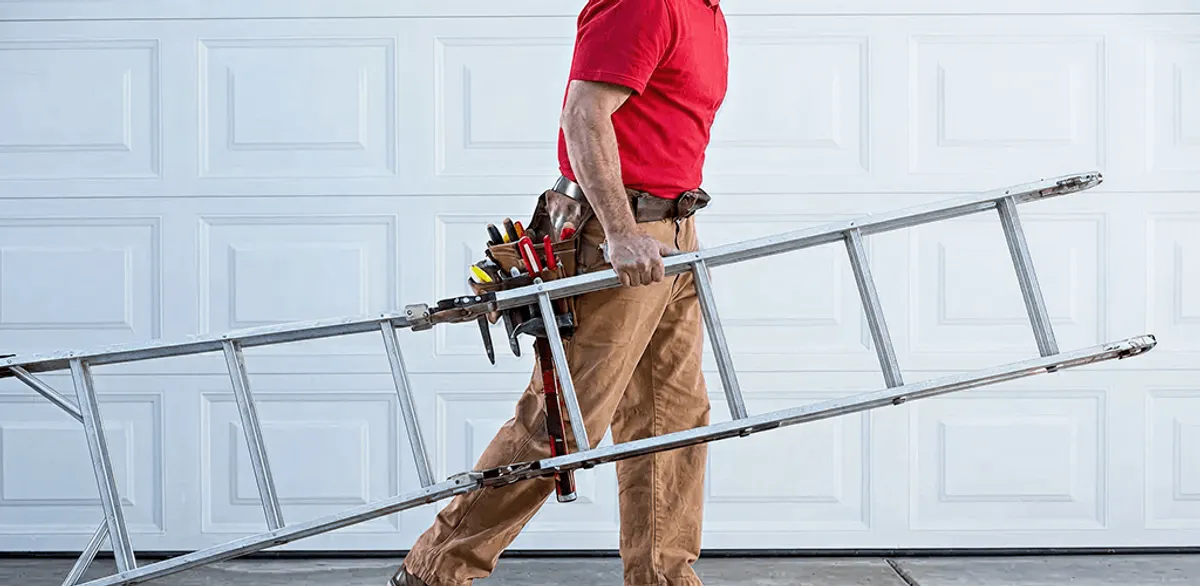 Garage door repair technician arriving with tools and ladder in Green Bay, WI
